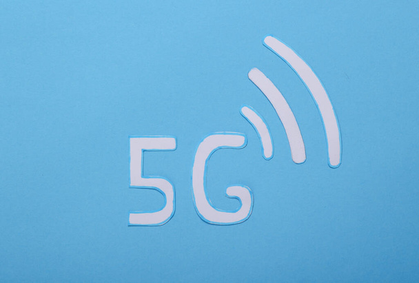 Paper cut Waves wi-fi icons and 5g on a blue background. - Photo, Image