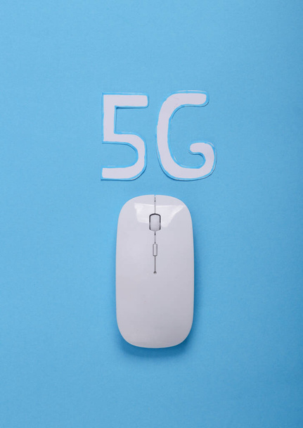 5G technology. Pc mouse and 5g iicon on blue background - Photo, Image