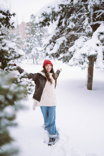 Happy young woman plays with a snow in sunny winter day. Walk in winter forest. Christmas,  holidays concept. - Photo, Image