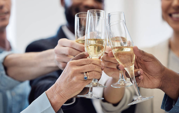 We deserve to celebrate after all our success. Closeup shot of a group of businesspeople celebrating while toasting with champagne at work - Zdjęcie, obraz