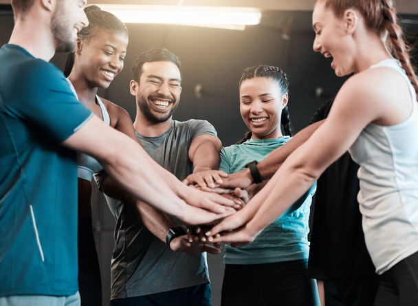 Youll never regret a workout. a group of friends with their hands stacked in motivation at the gym - Fotoğraf, Görsel