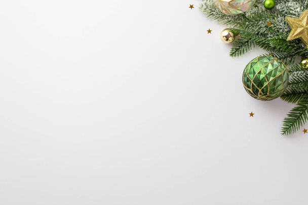 New Year concept. Top view photo of pine branch with stylish baubles gold star ornament and shiny confetti on isolated white background with copyspace - 写真・画像
