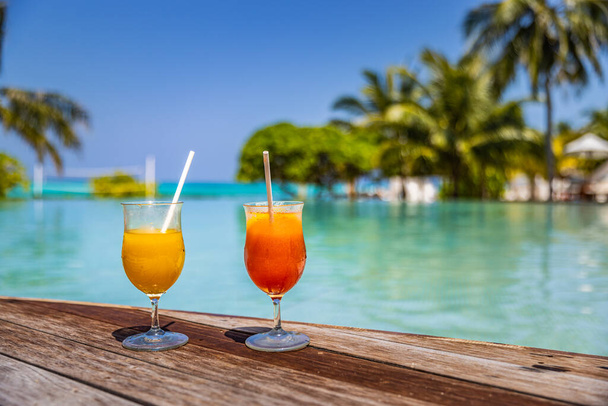summer cocktails on swimming pool edge of resort hotel  - Fotografie, Obrázek