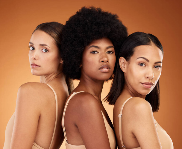 Beauty, diversity and skincare with woman friends in studio on a brown background for health or inclusion. Portrait, empowerment and wellness with a female model group posing for healthy skin. - 写真・画像