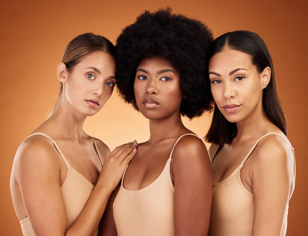 Beauty, diversity and skincare with a model woman group standing in studio on a brown background to promote real. Hair, face and skin with a female group posing for haircare or wellness together. - 写真・画像