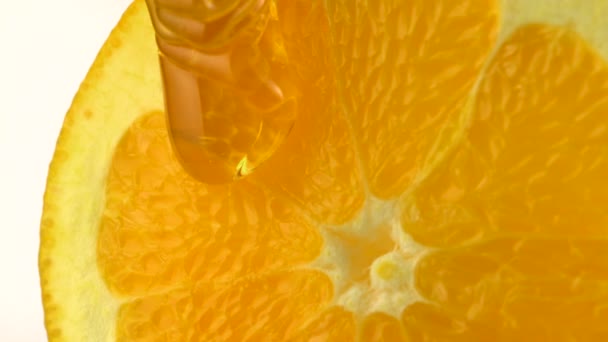 Pouring honey on orange - Footage, Video