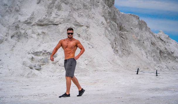 Strong lifestyle bodybuilder. Shirtless muscular man outdor posing. - Φωτογραφία, εικόνα