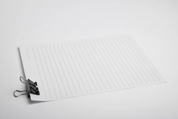 Sheet of paper with clip on white background - Zdjęcie, obraz