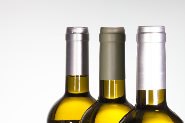 Detail of three wine bottle on white  background. - Fotografie, Obrázek