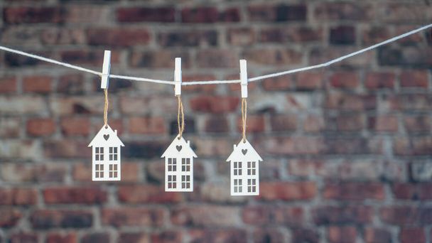 Houses, Clothesline and clip on brick wall background. Flat lay, top view, copy space, Buying a home composition.  - Φωτογραφία, εικόνα
