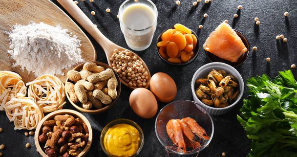 Composition with common food allergens including egg, milk, soya, nuts, fish, seafood, wheat flour, mustard, dried apricots and celery - Foto, imagen