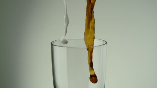 Pouring coffee and milk in glass - Footage, Video