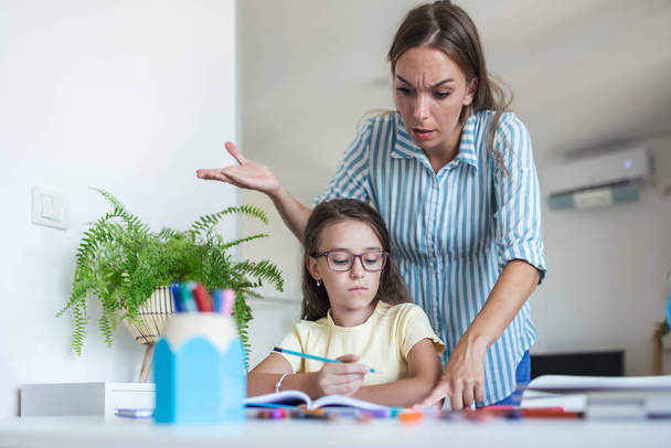 Stressed mother and son frustrated over failure homework, school problems concept. Sad little girl turned away from mother, does not want to do boring homework - Photo, Image