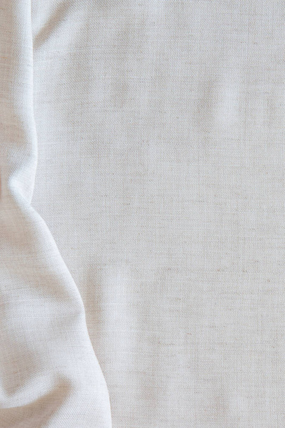 White crumpled linen fabric texture background. Natural off white wavy linen organic eco textiles canvas background. Top view. Top view - Zdjęcie, obraz