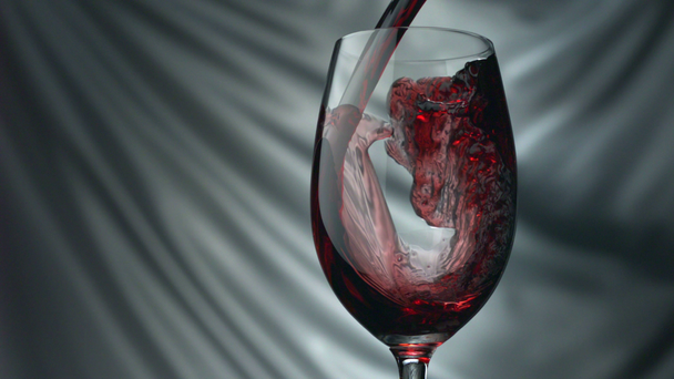 наливая красное вино в бокал - Кадры, видео
