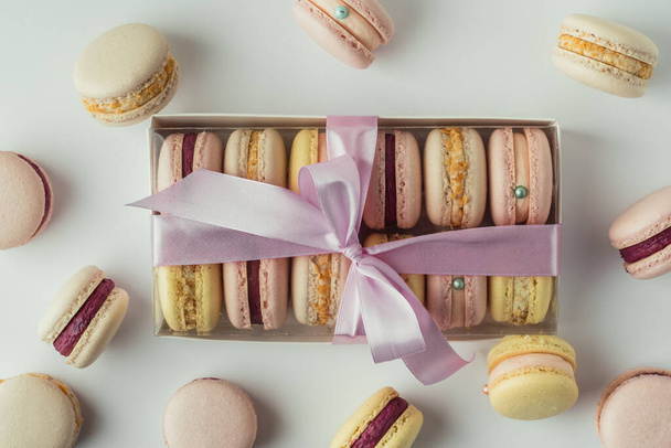 Gift transparent box full of multicolored macaroons on the white background. French dessert as a present. St Valentine's Day - Fotografie, Obrázek