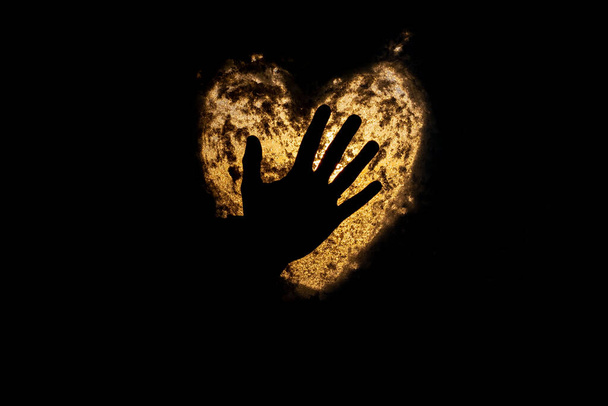 silhouette of woman hand on lighten heart symbol - 写真・画像