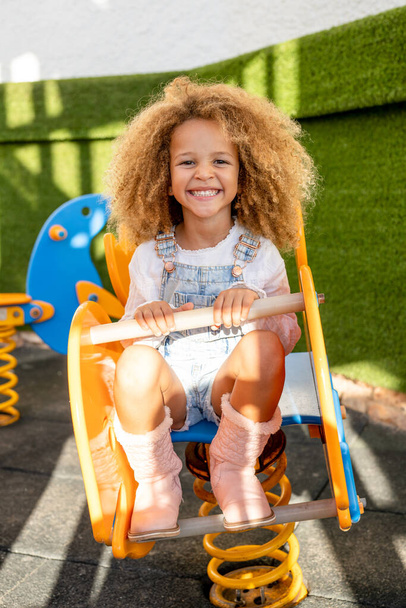 Active beautiful little child girl on playground outdoors. - Foto, Imagen