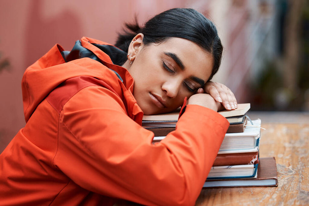 Ill just close my eyes for a bit. a young female student sleeping in a library at college - Fotografie, Obrázek