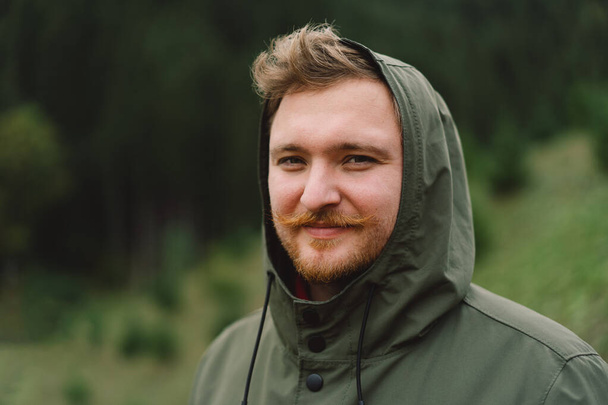 Portrait of Young happy male in the forest. Wellness concept and holistic rest. Portrait of a traveler - Valokuva, kuva