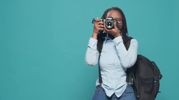 African american woman capturing image with camera, working as photographer and taking pictures. Going on holiday vacation trip to take photos and sightseeing, photograph lens. - Filmati, video