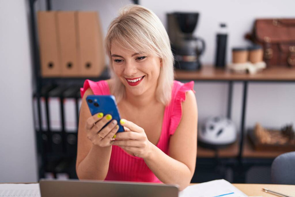 Young blonde woman business worker using laptop and smartphone at office - Zdjęcie, obraz
