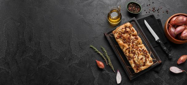 Composition with tasty Italian focaccia and ingredients on dark background with space for text - Fotografie, Obrázek