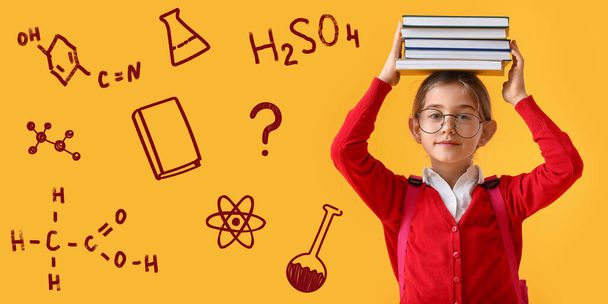 Cute little school girl with books and different drawings on yellow background - Foto, Bild