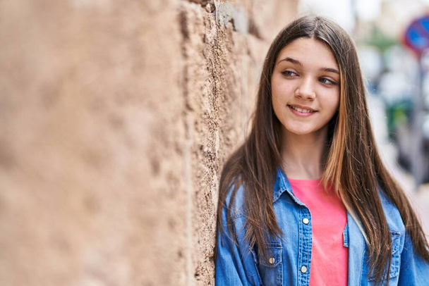 Adorable girl smiling confident looking to the side at street - Fotoğraf, Görsel