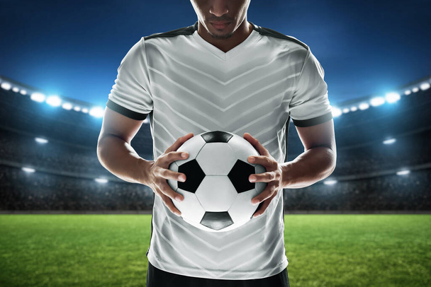 Soccer player holding ball in the stadium - Foto, Imagem