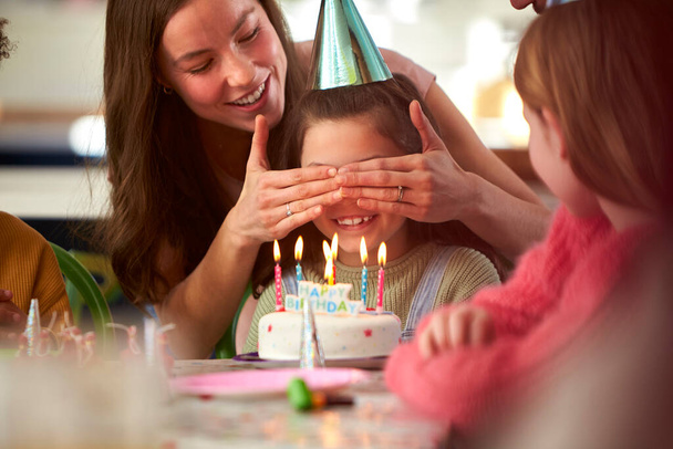 Girl With Candles On Birthday Cake At Surprise Party With Parents And Friends At Home - Foto, Bild