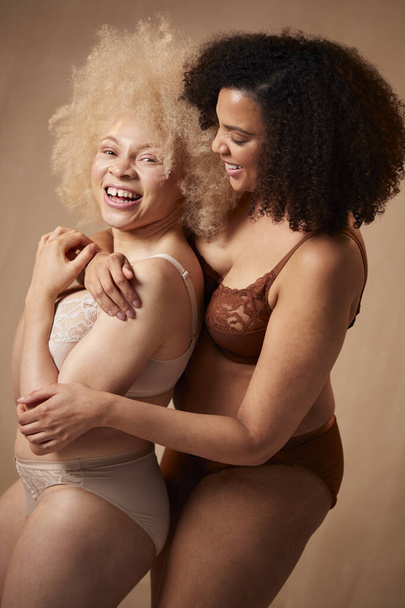 Shot Of Two Female Friends In Underwear Hugging Promoting Body Positivity - Фото, изображение