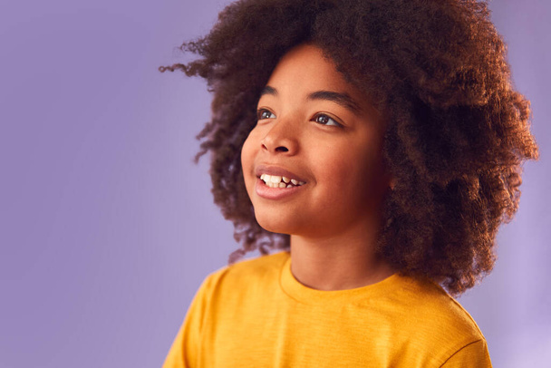 Studio Portrait Of Smiling Young Boy Shot Against Purple Background - Фото, зображення