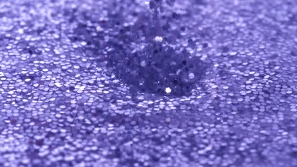 Dropping glitter in water - Video