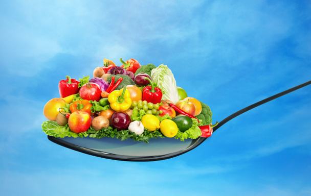 Spoon full of various fruit and vegetables - Фото, зображення