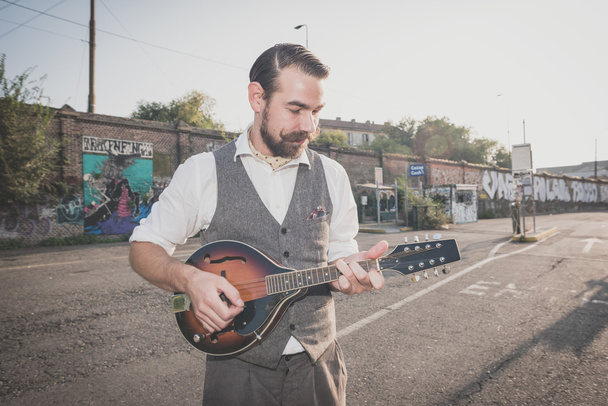 Man with big moustache playing mandolin - Photo, Image