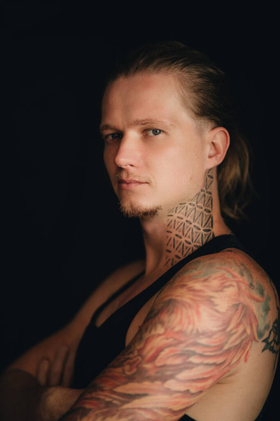 A portrait of tattooed blonde man. High quality photo - Foto, Bild