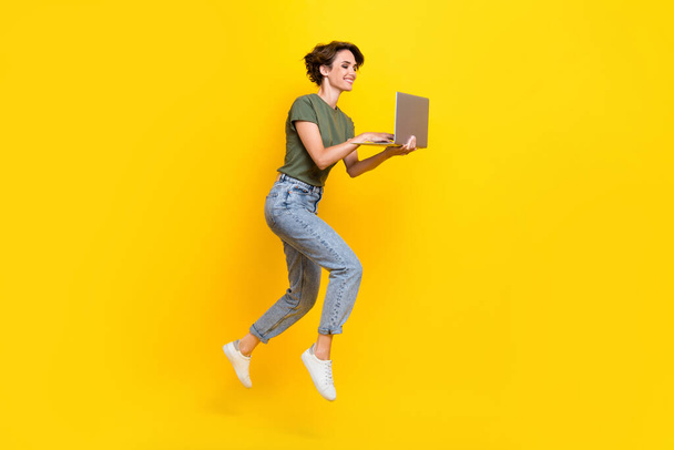 Full length photo of hardworking person lady dressed trendy clothes video talk meeting go empty space isolated on yellow color background. - Fotó, kép