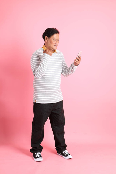 The 40s adult overweight Asian man standing on the pink background. - Foto, Imagen