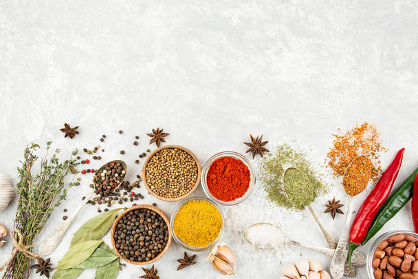 A variety of spices and herbs on a light table. Preparing the background. View from above. Ingredients for cooking. Table background menu. - Fotografie, Obrázek