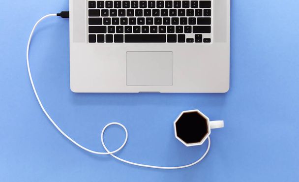 Laptop and coffee cup on lilac background, conceptual minimalism, flat lay, work and energy concept. - Foto, Bild