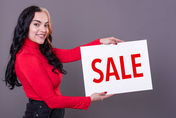 Beautiful woman holding a Sale sign - Photo, Image
