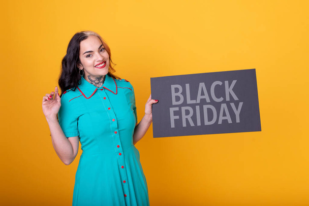 Beautiful woman holding a Black Friday sign - Photo, Image