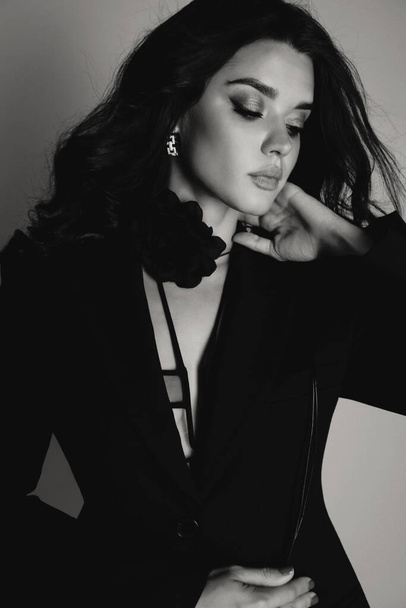 fashion outdoor photo of beautiful woman with dark hair in elegant black lingerie and jacket posing in studio - Φωτογραφία, εικόνα
