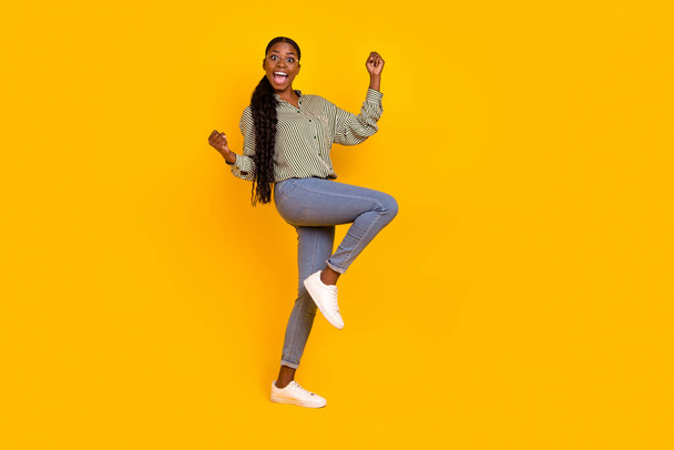 Full size photo of delighted overjoyed person raise fists celebrate luck isolated on yellow color background. - Foto, Imagen