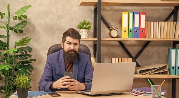 positive confident mature man freelancer use online computer communication at office holding coffee, modern life. - Φωτογραφία, εικόνα