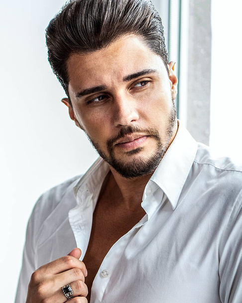 Portrait of successful, elegant man wearing white shirt, looking away. Handsome male model with beard. Closeup photo - 写真・画像