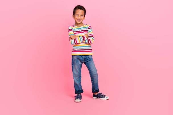 Full length photo of sweet cheerful good mood boy dressed striped shirt jeans outfit arms crossed isolated on pink color background. - Foto, immagini