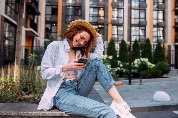 Photo of cute adorable young lady sitting stairs typing modern device outside urban city street - Foto, Bild