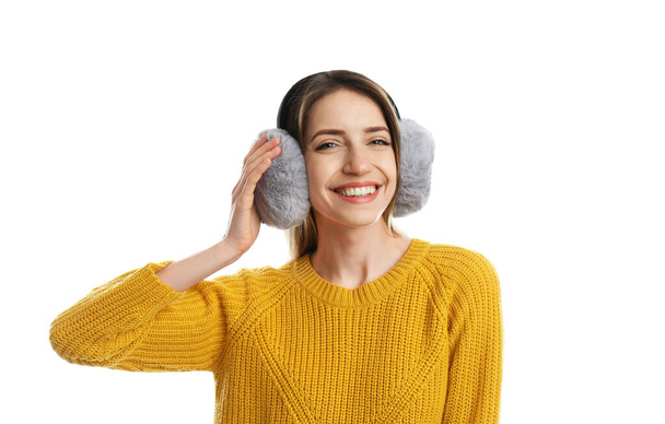 Happy woman wearing warm earmuffs on white background - Foto, Imagem